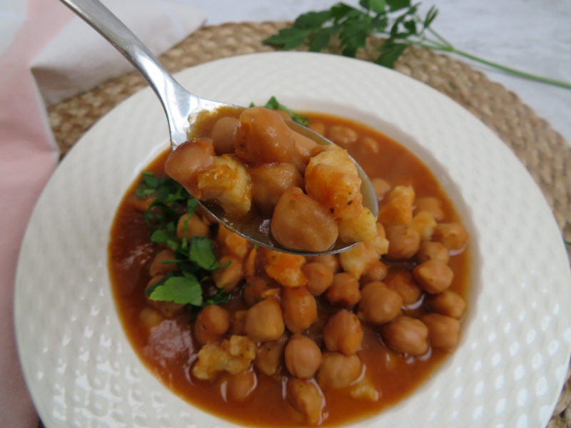 slow cooker chickpea stew with codfish served in a platter -close up view