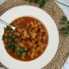 slow cooker chickpea stew with codfish served in a platter -close up view